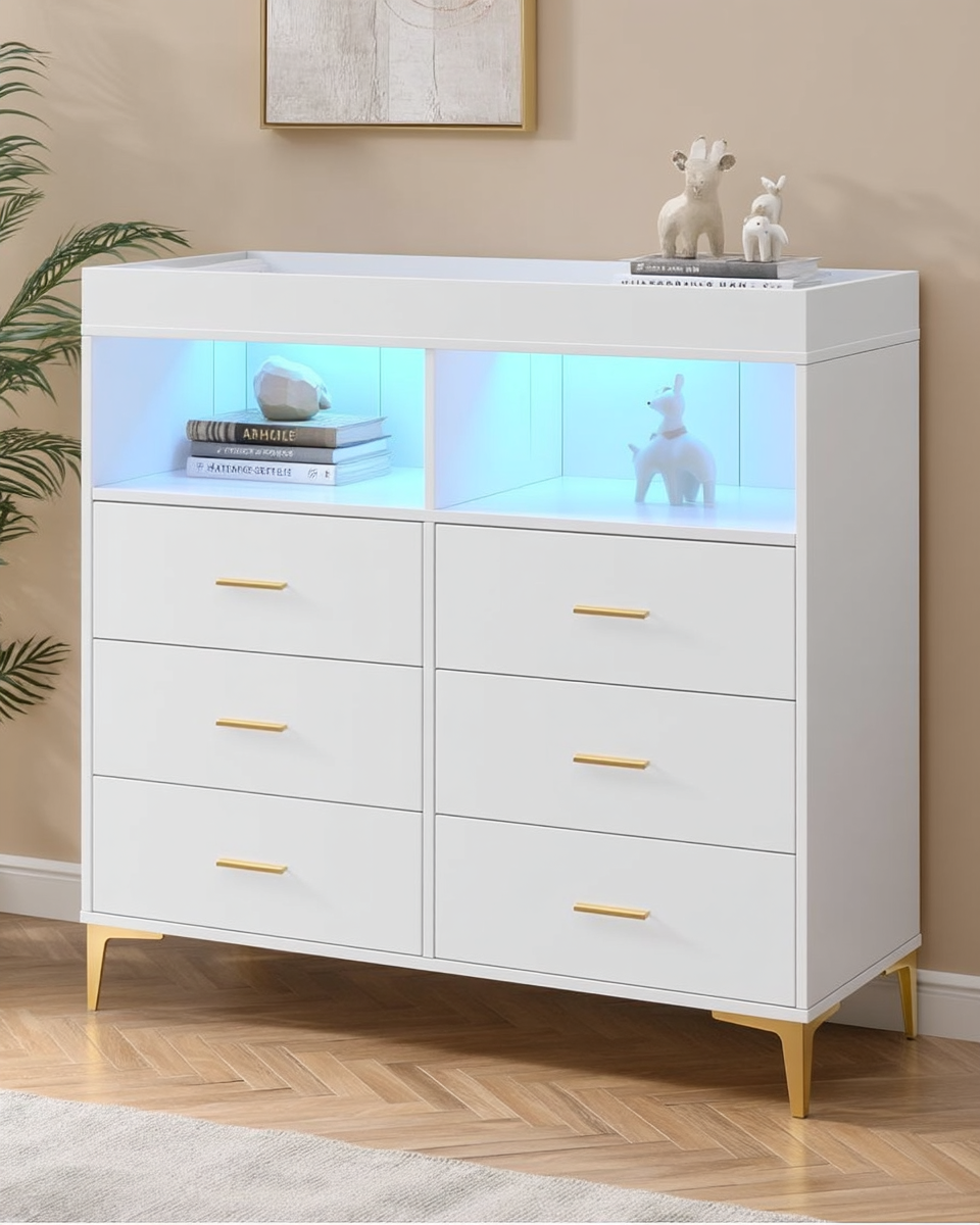 White six-drawer nursery dresser and changing table with gold hardware, tapered gold legs, and blue LED-lit open top shelves styled with books and small figurines